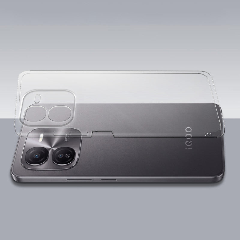Transparent hard back case being installed on iQOO Z9x 5G showing perfect alignment and camera protection fit