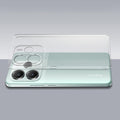 Transparent hard back case being installed on Redmi Note 14 5G showing perfect alignment and camera protection fit
