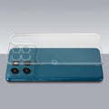 Transparent hard back case being installed on Motorola G57 Power 5G showing perfect alignment and camera protection fit